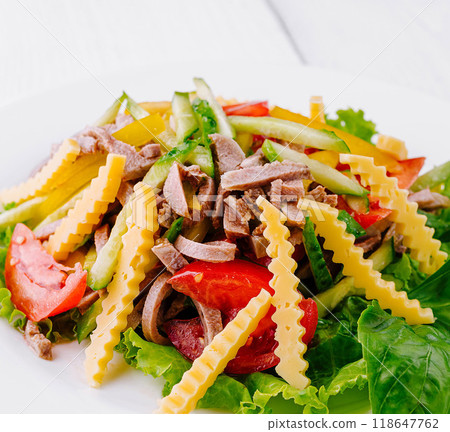 Fresh salad with lettuce, tomatoes, beef tongue and cheese decorated with wavy cheese slices 118647762