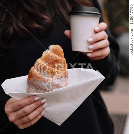 Woman holding fresh pastry and coffee outdoors Woman holding fresh pastry and coffee outdoors 118647790