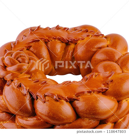 Round loaf of bread decorated with dough flowers baking on white background 118647803
