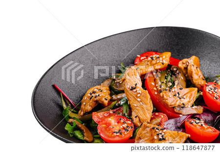 Delicious salad with grilled chicken and fresh vegetables on black plate Delicious salad with grilled chicken and fresh vegetables on black plate 118647877