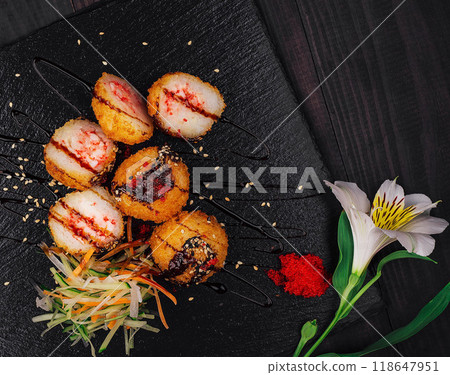 Delicious fried sushi balls being served on black stone plate 118647951