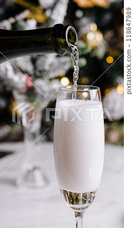Pouring sparkling wine into flute glass Pouring sparkling wine into flute glass 118647989