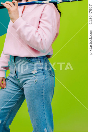 Woman holding badminton racket on green background 118647997