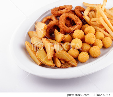 Big plate of french fries, potato wedges, onion rings and croquettes on white background 118648043