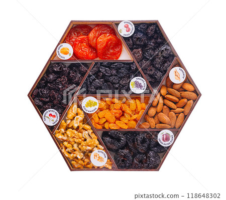 Hexagon shaped wooden box containing dried fruits and nuts 118648302