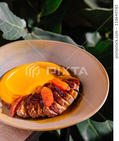Delicious duck breast with orange sauce and mashed sweet potatoes being served on a plate Delicious duck breast with orange sauce and mashed sweet potatoes being served on a plate 118648592