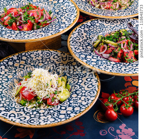 Plates with traditional bulgarian shopska salad on restaurant table setting 118648733