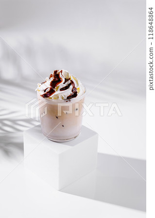 Iced coffee with whipped cream and chocolate sauce on white background Iced coffee with whipped cream and chocolate sauce on white background 118648864