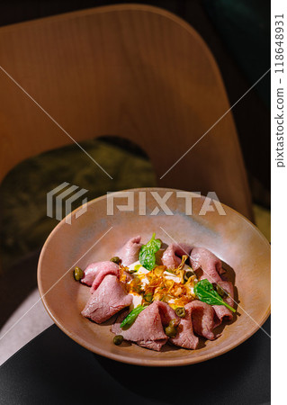 Delicious vitello tonnato dish served on elegant plate in restaurant setting Delicious vitello tonnato dish served on elegant plate in restaurant setting 118648931