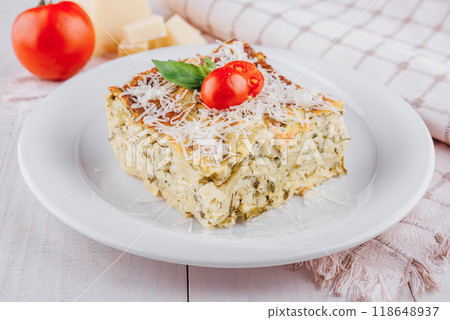 Slice of vegetarian lasagna garnished with fresh ingredients on white plate Slice of vegetarian lasagna garnished with fresh ingredients on white plate 118648937