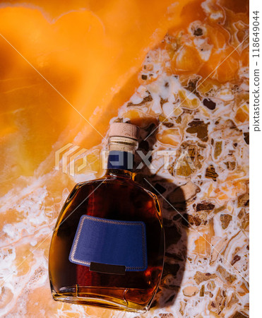 Bottle of brandy resting on an onyx surface Bottle of brandy resting on an onyx surface 118649044
