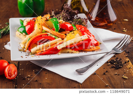 Colorful vegetarian jicama salad with bell peppers and herbs on rustic wooden table 118649071