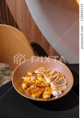 Delicious rolled pancakes with toasted marshmallow and caramel sauce topping in restaurant Delicious rolled pancakes with toasted marshmallow and caramel sauce topping in restaurant 118649114