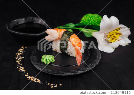 Delicious king prawn nigiri sushi served on black slate plate Delicious king prawn nigiri sushi served on black slate plate 118649115