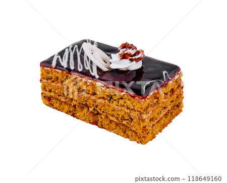 Delicious honey cake layered with chocolate glaze and topped with walnut and whipped cream 118649160