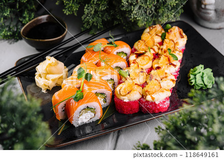 Delicious sushi rolls being served on plate with soy sauce and wasabi 118649161
