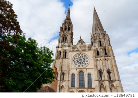 Chartres, France. Cathedral with two tall spires and a large rose window in the center of the facade Chartres, France. Cathedral with two tall spires and a large rose window in the center of the facade 118649781