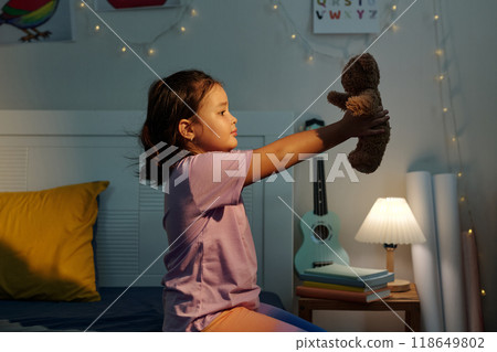 Girl Playing With Her Toy Girl Playing With Her Toy 118649802