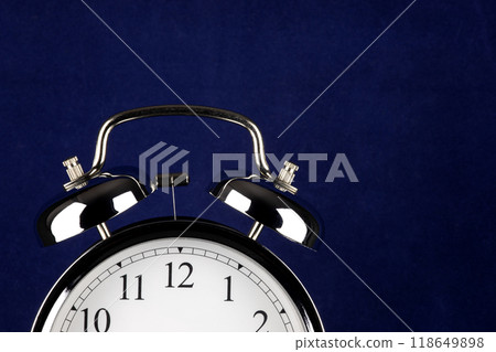 Alarm Clock Dial and Bells Partial View on a Blue Background 118649898