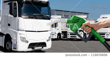 Man with biofuel filling nozzle on a background of truck Man with biofuel filling nozzle on a background of truck 118650606