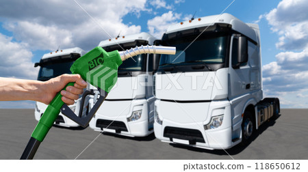 Man with biofuel filling nozzle on a background of truck Man with biofuel filling nozzle on a background of truck 118650612