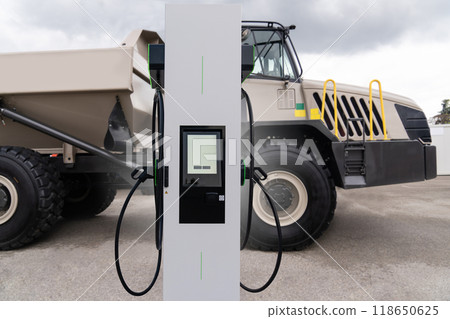 Electric vehicles charging station on a background of a trucks. Concept Electric vehicles charging station on a background of a trucks. Concept 118650625