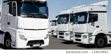 Fleet of white semi trucks in a rows Fleet of white semi trucks in a rows 118650691