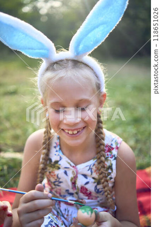 a llittle girl paint eggs at the easter picnic a llittle girl paint eggs at the easter picnic 118651026
