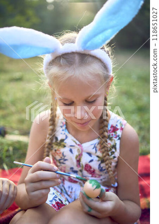 a llittle girl paint eggs at the easter picnic a llittle girl paint eggs at the easter picnic 118651027