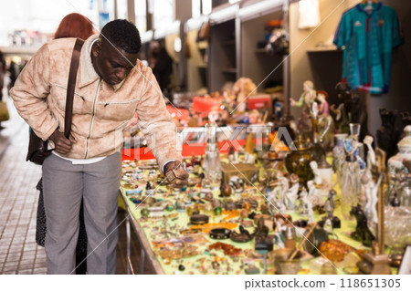Man chooses antiques at a flea market Man chooses antiques at a flea market 118651305