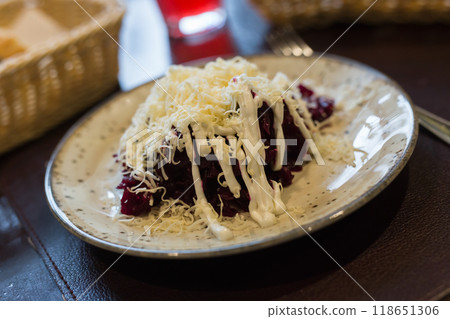 Mix of beets, cheese, mayonnaise on a plate in restaurant Mix of beets, cheese, mayonnaise on a plate in restaurant 118651306