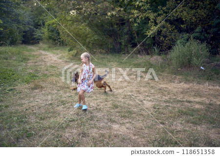 little girls sisters play with german shepherd dog during easter picnic in the garden little girls sisters play with german shepherd dog during easter picnic in the garden 118651358