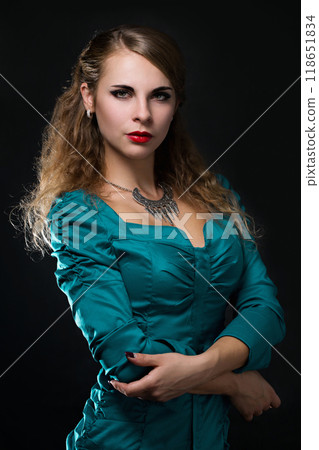 Portrait of a beautiful young woman in a silver vintage necklace Portrait of a beautiful young woman in a silver vintage necklace 118651834