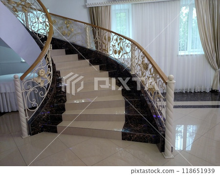 Staircase to the second floor is lined with beige ceramic tiles light interior horizontal Staircase to the second floor is lined with beige ceramic tiles light interior horizontal 118651939