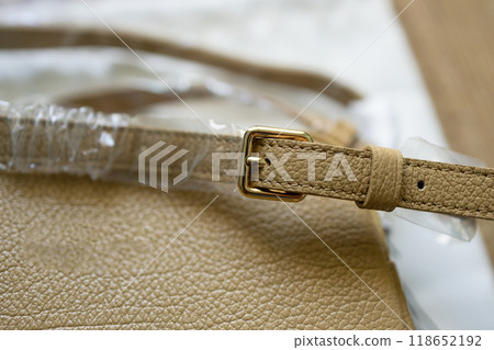 Leather women's bag with a belt on a light background. High quality  118652192