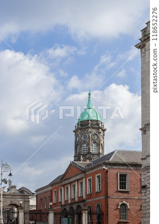 Clock tower of Dublin Castle with distinctive green dome and clock face under blue cloudy sky Clock tower of Dublin Castle with distinctive green dome and clock face under blue cloudy sky 118652276