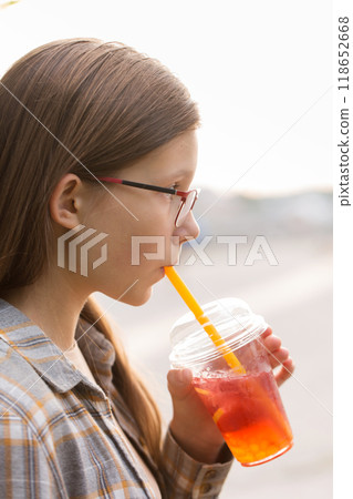 A girl drinks bubble tea on a walk 118652668