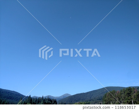 View of Hoverla Mountain in the Carpathians from the countryside grows green grass and a design for drying grass horizontal 118653017