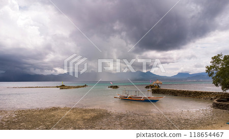 boat aground at low tide in the sea, tropical coast, rainy and typhoon season, Philippine boat 118654467