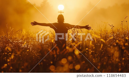 A solitary figure stands amidst tall grass, welcoming the dawn with open arms as the sun rises behind them, creating a serene atmosphere A solitary figure stands amidst tall grass, welcoming the dawn with open arms as the sun rises behind them, creating a serene atmosphere 118654483