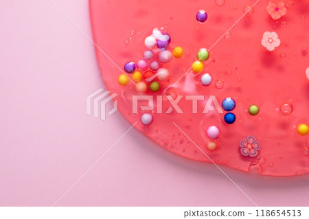 Colorful gel texture, clear skincare cream with bubbles and decorative figurines background, transparent beauty serum, colored cosmetic product close up Colorful gel texture, clear skincare cream with bubbles and decorative figurines background, transparent beauty serum, colored cosmetic product close up 118654513