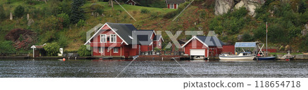 Beautiful red boat sheds and cottages at the shore of the Tengs River, Egersund, Norway. Beautiful red boat sheds and cottages at the shore of the Tengs River, Egersund, Norway. 118654718