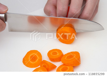 Cut the carrots into chunks Cut the carrots into chunks 118655299