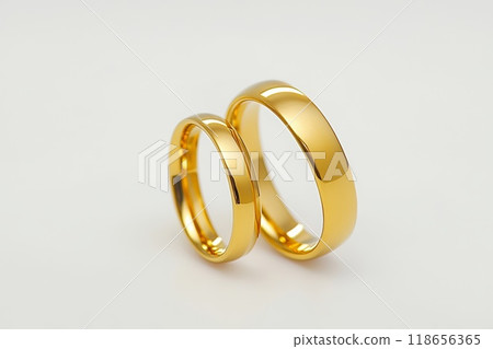 Pair of gold Wedding ring on a white background, close up. 118656365