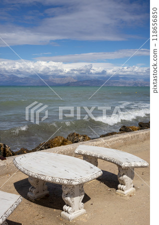 Stone table and bench on the coast, Corfu, Greece 118656850