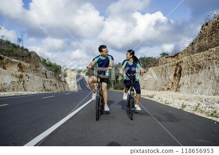 male and female couple athlete biking together male and female couple athlete biking together 118656953