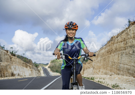 cheerful female biker enjoying riding bicycle cheerful female biker enjoying riding bicycle 118656970