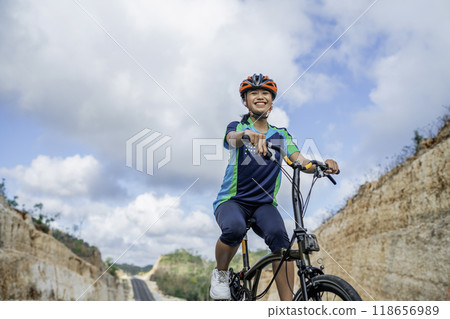 woman biker enjoying riding bicycle outdoors 118656989