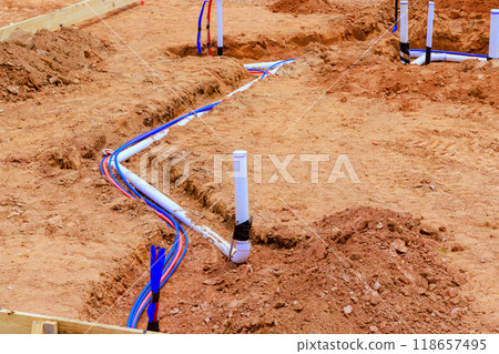 In preparation for pouring of concrete on foundation of a new house, underground water sanitary pipes are laid down In preparation for pouring of concrete on foundation of a new house, underground water sanitary pipes are laid down 118657495