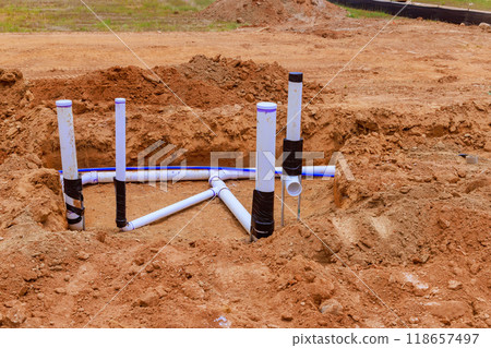 Installation underground water pipes sanitary pipes for before pouring concrete in foundation of new house 118657497
